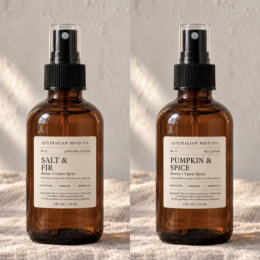 Salt & Fir and Pumpkin & Spice room and linen sprays side by side in amber glass bottles